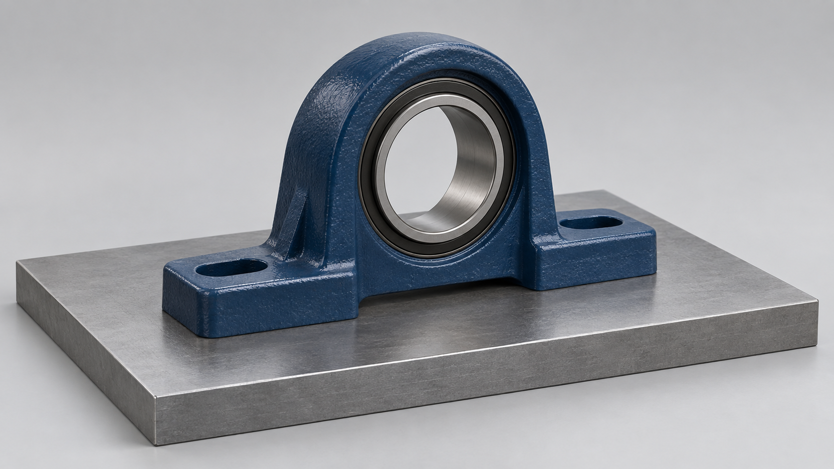 Generic pillow block housing resting on a flat steel support plate with an empty bearing bore